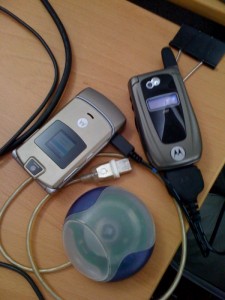 LocaModa's test cell phones. Shown with original iMac puck mouse to illustrate age of technology.